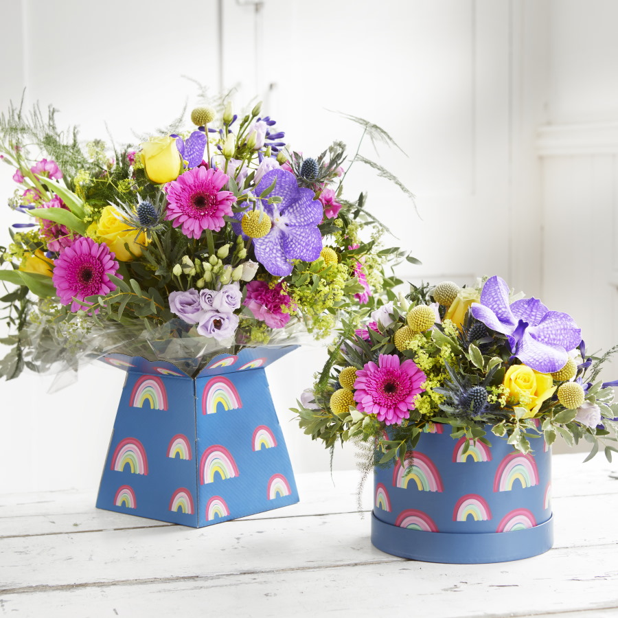 Mother's Day flowers in a rainbow hat box with Gerbera flowers.